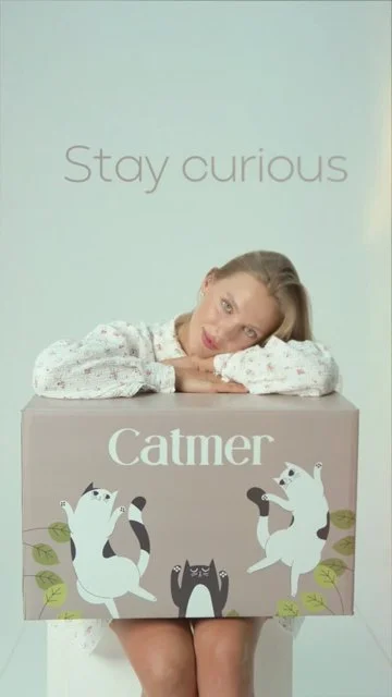 Mint studio launch teaser with model, cat and branded product box.