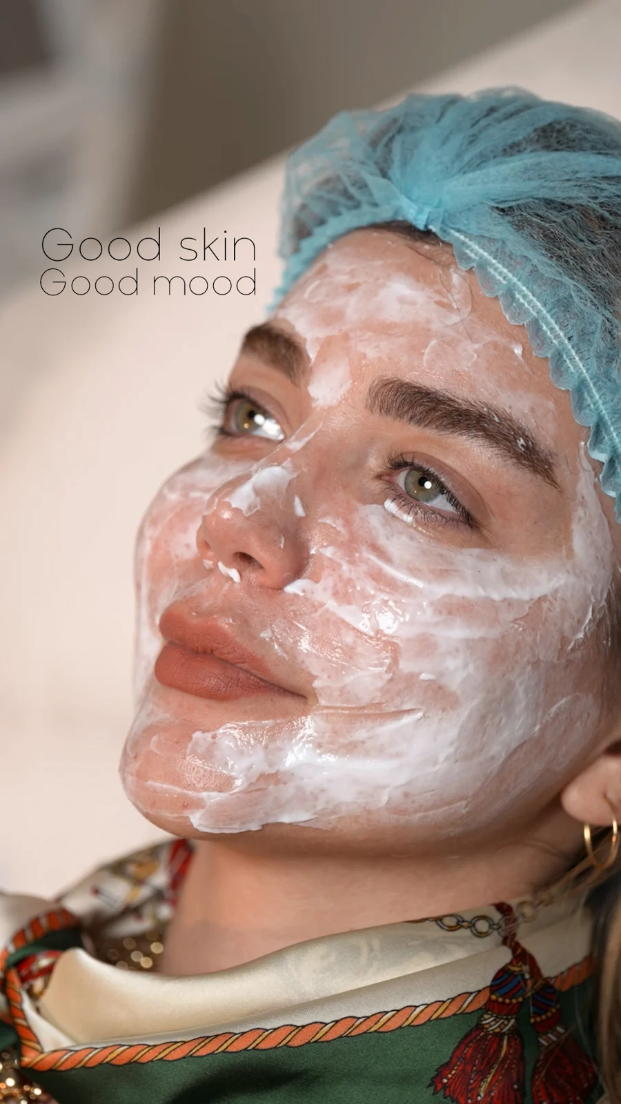 Facial mask treatment with “Good skin Good mood” text.