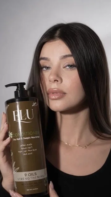 Neutral-background model and brown ELU conditioner bottle.